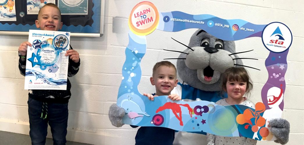 Pupil with certificate and pupils meeting Stanley the seal